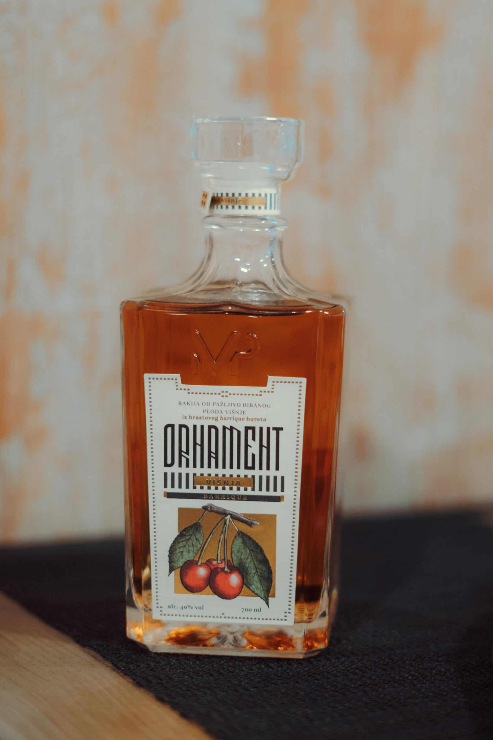 Premium cherry flavored rakija in a glass bottle with detailed label.