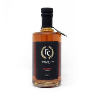 Premium Serbian plum brandy in a sleek glass bottle.