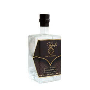 Elegant pear brandy in a clear glass bottle with black and gold label.