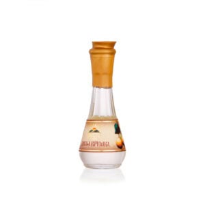Traditional Balkan fruit brandy in elegant glass bottle with golden cap.