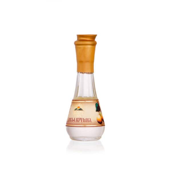 Traditional Balkan fruit brandy in elegant glass bottle with golden cap.