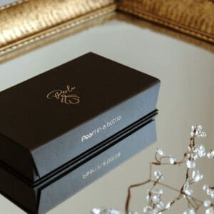 Elegant black box for premium pearl in a bottle, perfect for gifting or display.