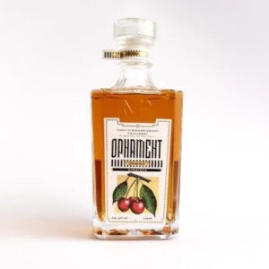 Premium cherry-flavored rakija in a glass bottle.
